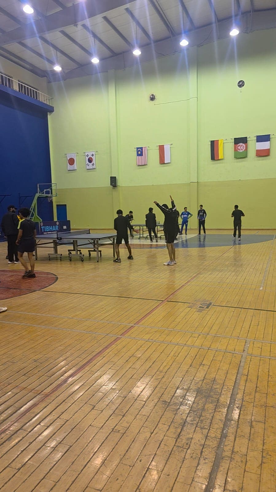 A person playing table tennis, hitting the ball with a paddle.